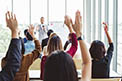 CECL Implementation People in Classroom Raising Their Hands